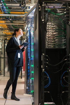 Server room technician gazes up  at a server
