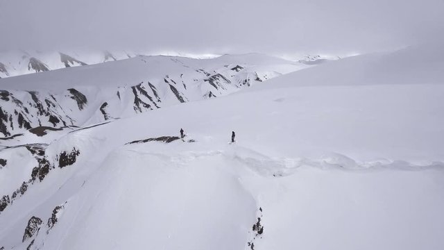 Aerial, skiers on Iceland mountain summit