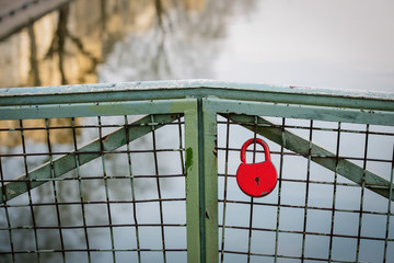 Red lock on a bridge over the Canal Saint-Martin, Paris