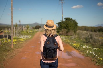 Woman standing with her backpack on a sunny day