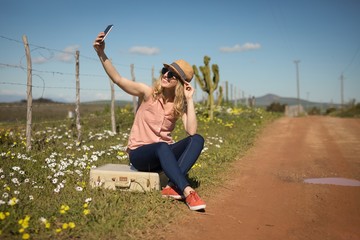 Woman taking selfie with mobile phone