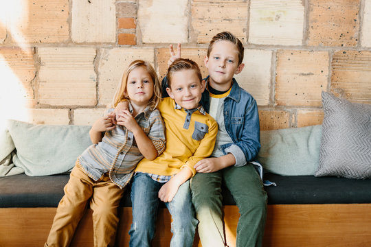 Portrait of three adorable young brothers posing together.