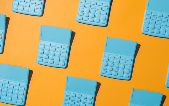 Blue pocket calculators on orange background.