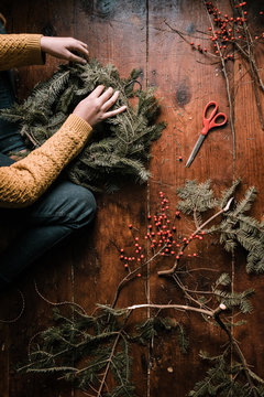 young woman making a wreath