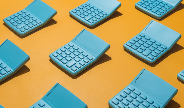 Blue pocket calculators on orange background.