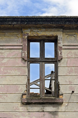 Broken window of house in ruins without internal walls