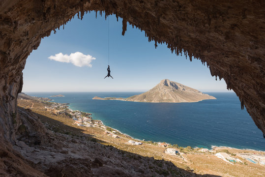 Man hanging upside down  from a rope