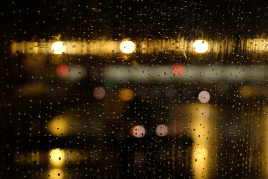 Rain drops on the window of an airplane.