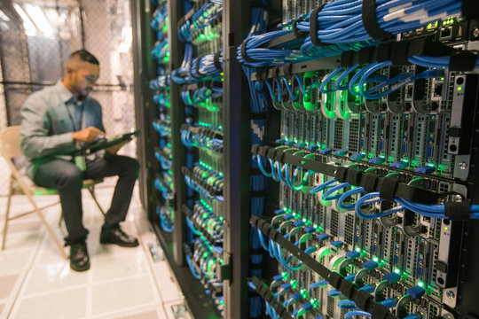 Bank of servers with technician in background