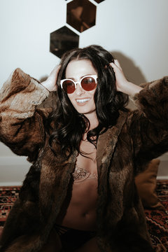 Fashion young woman wearing fur jacket 70s glam New Years Party