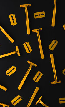 Yellow Razor blades for shaving on black background.