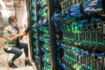 Bank of servers with technician in background