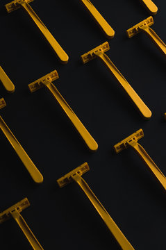 Yellow Razor blades for shaving on black background.