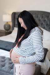 Pregnant woman touching her stomach