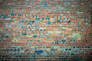 Rough old brick wall with a darkening at the edges