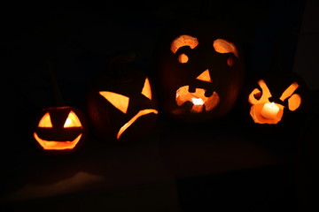 Jack O'Lanterns Glowing with Candles on a Front Porch at Night 