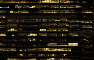 office building at night. Late night at work. Glass curtain wall office building