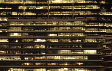 office building at night. Late night at work. Glass curtain wall office building