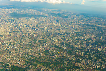 panorama view of city and cloud and sky from the windows of airplane flying in sunny day at attitude 22000 feets