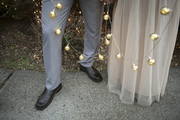 Christmas Couples Holding Hands and Gold Mercury Glass String Lights