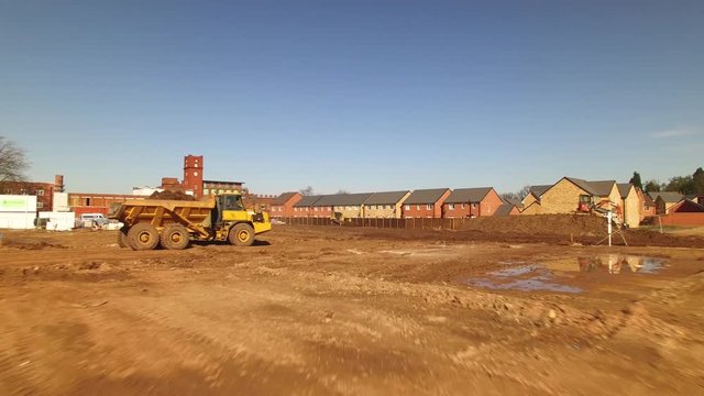 A moving drone shot inside a construction site where the construction is on going.