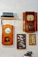 old clocks, abacus hanging on a white wall