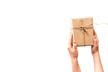 woman hands holding a wrapped box. Gift delivery concept