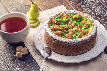 Homemade Christmas or New Year holiday pear pie decorated in a rustic style. Concept of festive desserts