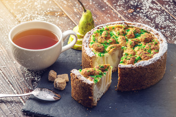 Homemade Christmas or New Year holiday pear pie decorated in a rustic style. Concept of festive desserts