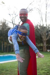 Naklejka premium Son and father pretending to be a superhero
