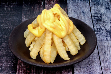 Volcano French fries as French fries topped with cheese arranged is like the volcano .