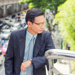 Happy businessman going up the stairs and bad traffic in a hurry in rush hour