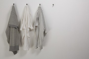 Various t shirts hanging on hook