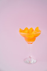 A wineglass of peeled tangerines