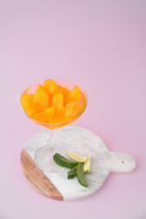 A wineglass of peeled tangerines