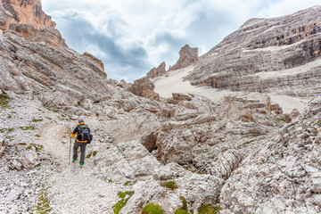 Trekker walking in a awesome and majestic dolomitic landscape, Masarè, Travenanzes Valley, Cortina...