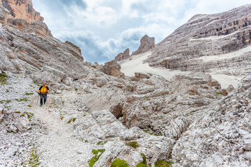 Trekker walking in a awesome and majestic dolomitic landscape, Masarè, Travenanzes Valley, Cortina...