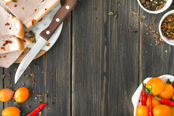 A smoked brisket sliced with a knife and yellow cherry tomatoes