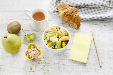 Yellow notebook and healthy food on wooden table