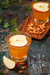 Hot drink of apple tea with cinnamon stick. Hot drink with apples for autumn or winter.