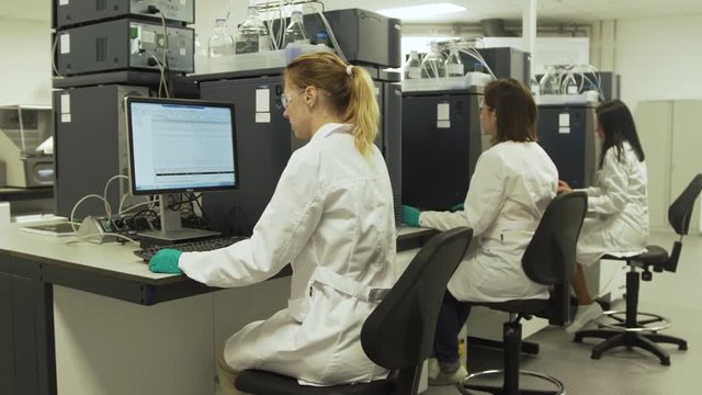 Scientists in the laboratory in front of computers do scientific research. Female researcher working on a computer in a laboratory.