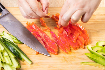 the chef cuts red fish