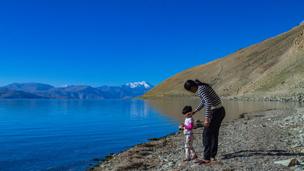 Mother and daughter playing besides the Tsomoriri lake in Ladakh India