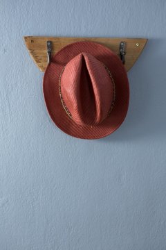 Straw hat hanging on hook