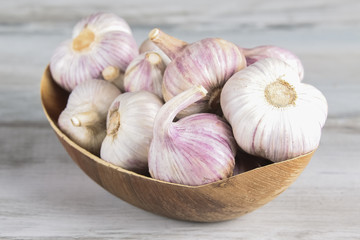 Close-up garlic bulbs and garlic cloves on wooden background