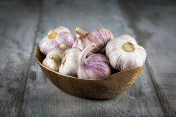 Close-up garlic bulbs and garlic cloves on wooden background