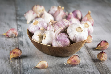 Close-up garlic bulbs and garlic cloves on wooden background