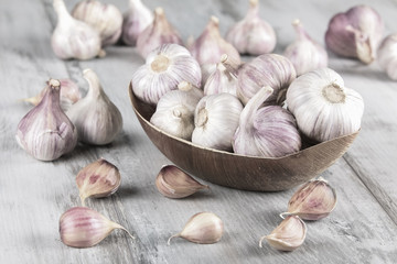 Close-up garlic bulbs and garlic cloves on wooden background