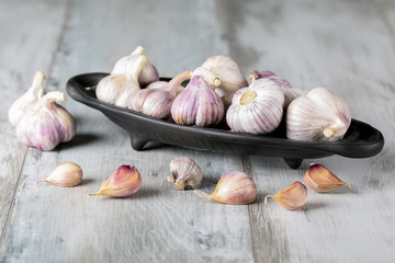 Close-up garlic bulbs and garlic cloves on wooden background