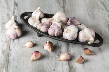 Close-up garlic bulbs and garlic cloves on wooden background